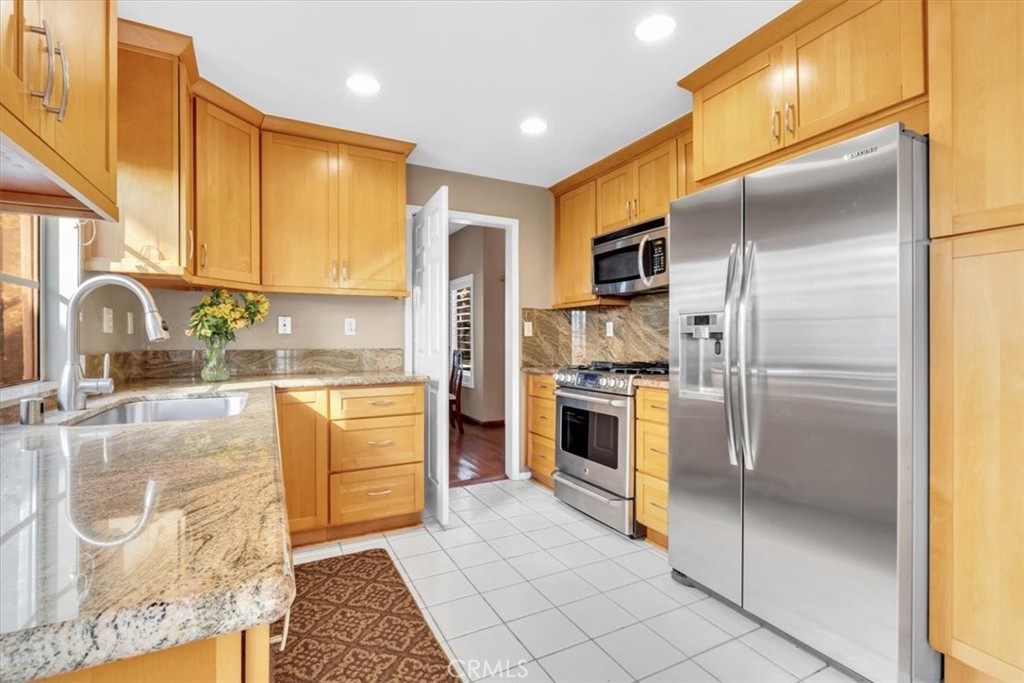 10 St John Dana Point, CA 92629 - Photo 6 of 31 a kitchen with stainless steel appliances granite countertop a refrigerator a stove and a sink with granite countertops