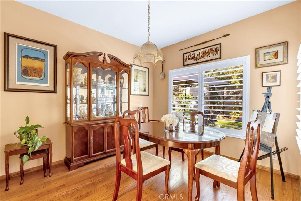 10 St John Dana Point, CA 92629 - Photo 8 of 31 a dining room with furniture a window and wooden floor