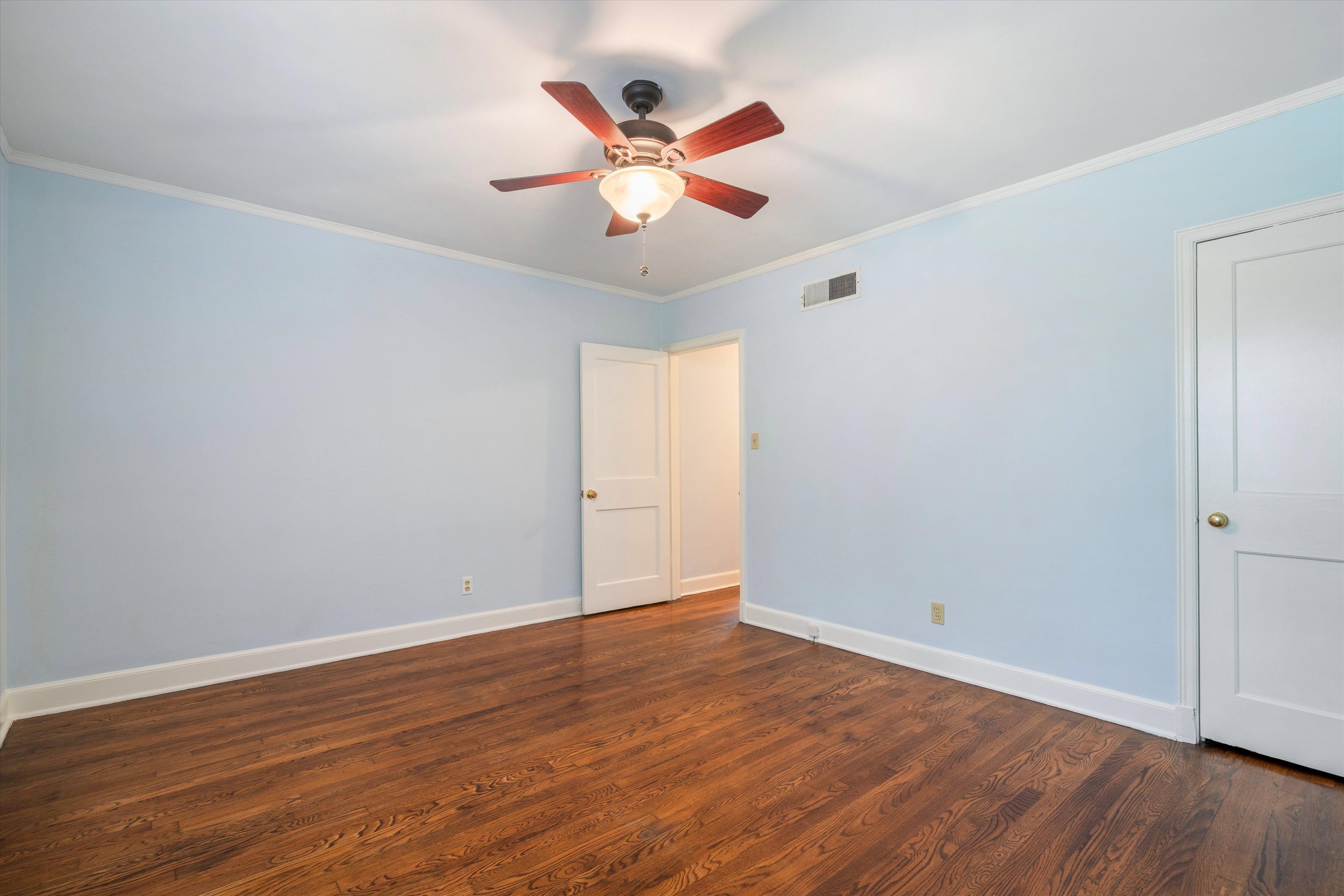 17 North Ashlawn Road Memphis, TN 38112 - Photo 15 of 28 Spare room featuring ornamental molding, dark wood finished floors, and a ceiling fan