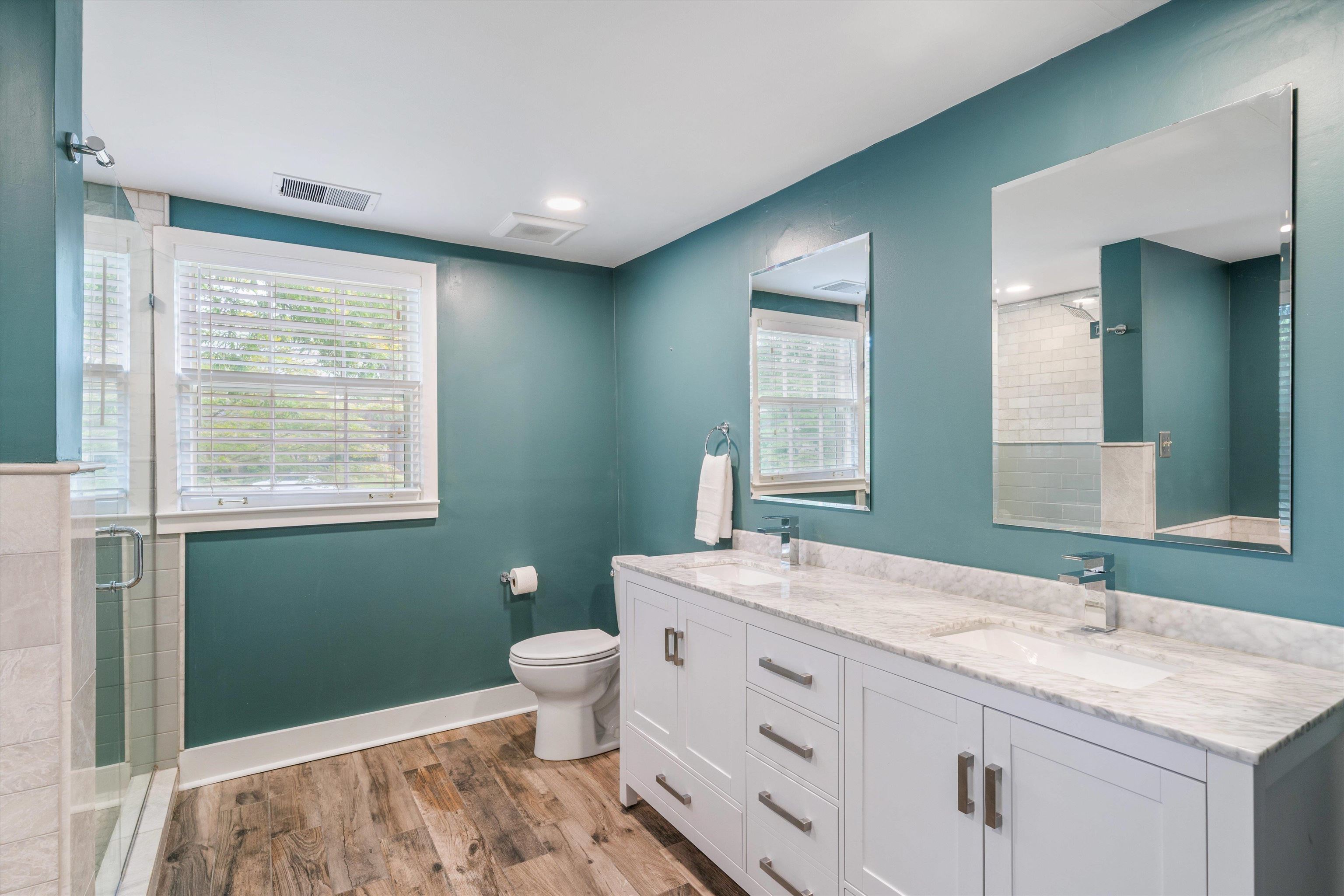 17 North Ashlawn Road Memphis, TN 38112 - Photo 20 of 28 Bathroom with light wood-style floors, a stall shower, and double vanity
