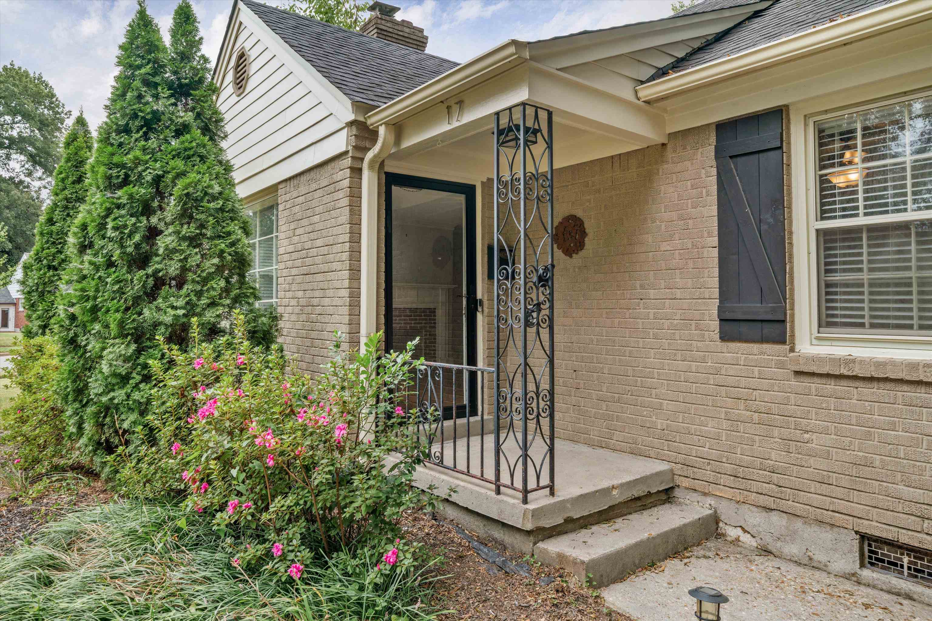 17 North Ashlawn Road Memphis, TN 38112 - Photo 2 of 28 Entrance to property with brick siding, a chimney, and a shingled roof