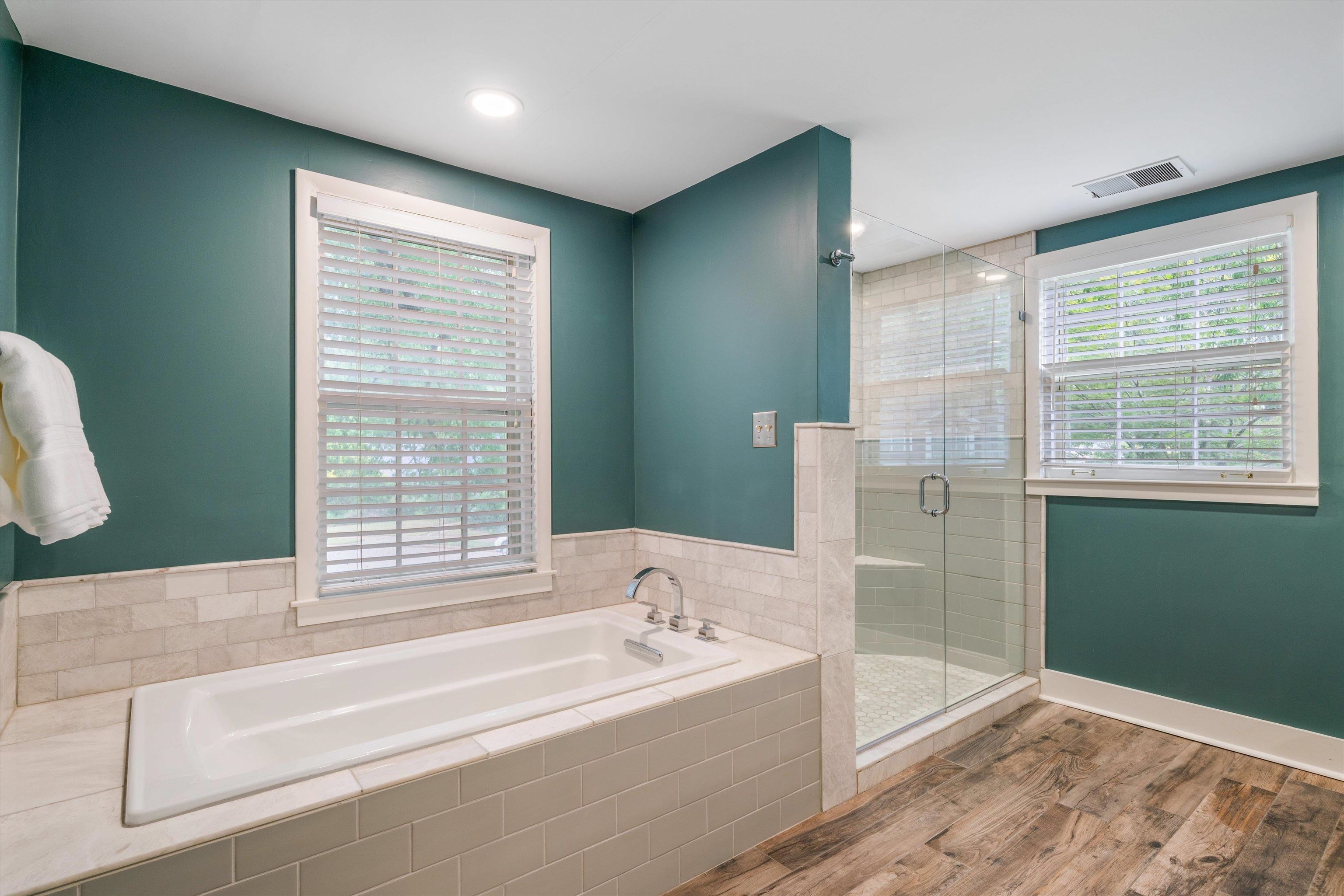 17 North Ashlawn Road Memphis, TN 38112 - Photo 21 of 28 Bathroom featuring light wood-style flooring, a stall shower, and a garden tub