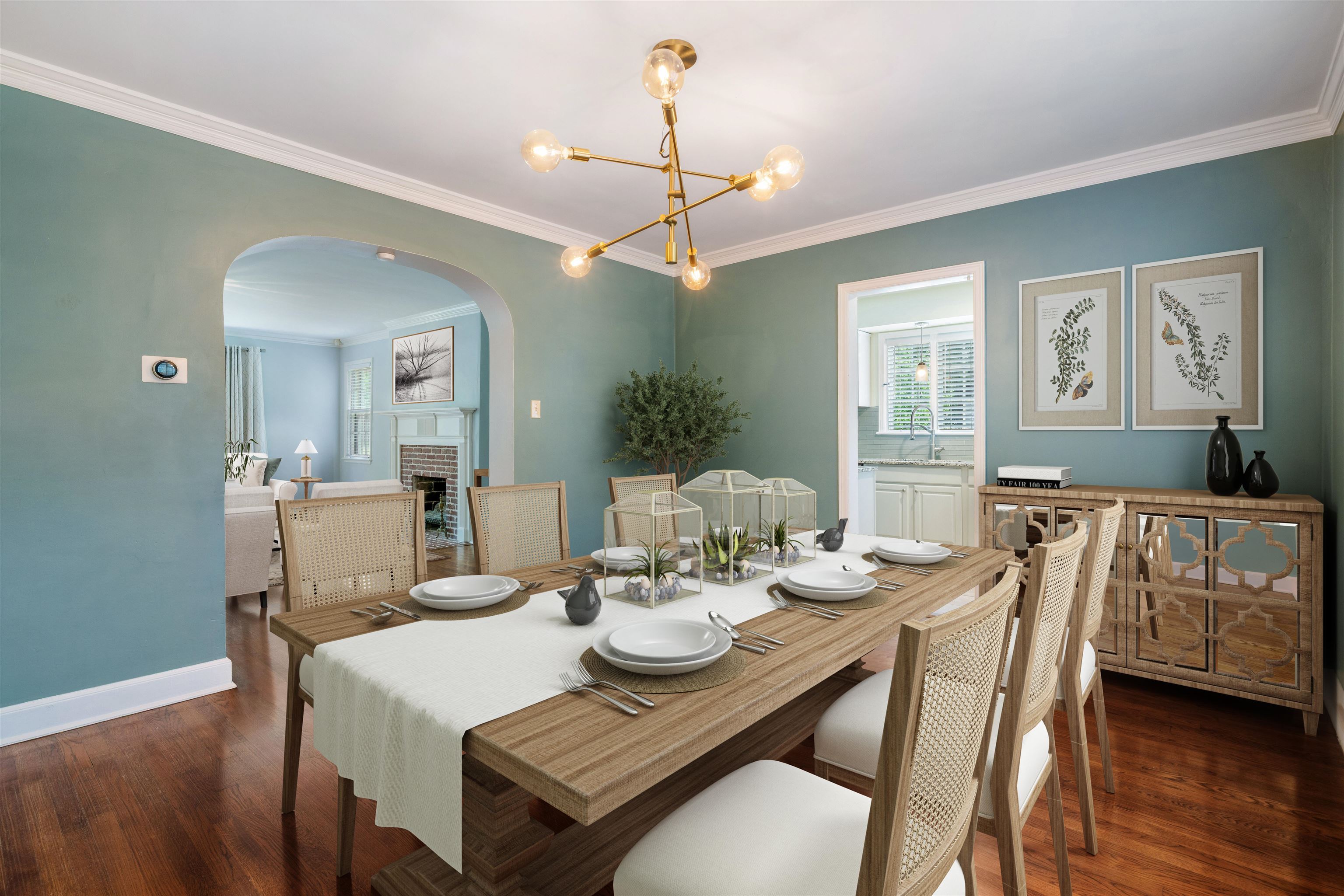 17 North Ashlawn Road Memphis, TN 38112 - Photo 6 of 28 Dining room featuring crown molding, a brick fireplace, arched walkways, dark wood finished floors, and a chandelier. Stagged for your review.