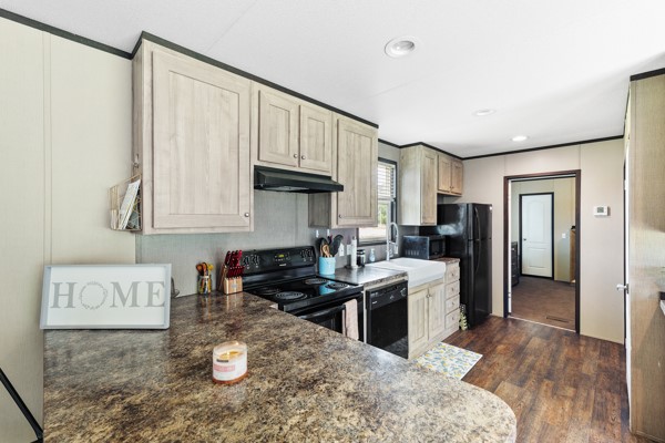 148 A Rogers Road New Waverly, TX 77358 - Photo 15 of 31 a kitchen with a refrigerator and a stove top oven