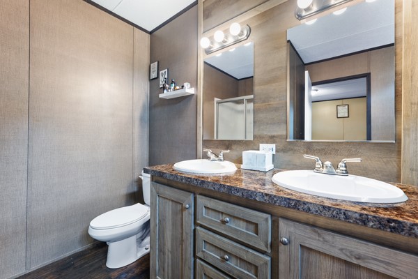 148 A Rogers Road New Waverly, TX 77358 - Photo 17 of 31 a bathroom with a granite countertop toilet sink and mirror