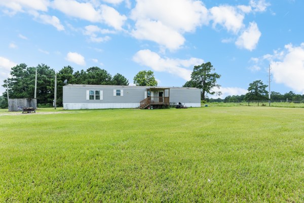 148 A Rogers Road New Waverly, TX 77358 - Photo 24 of 31 a view of a house with a big yard