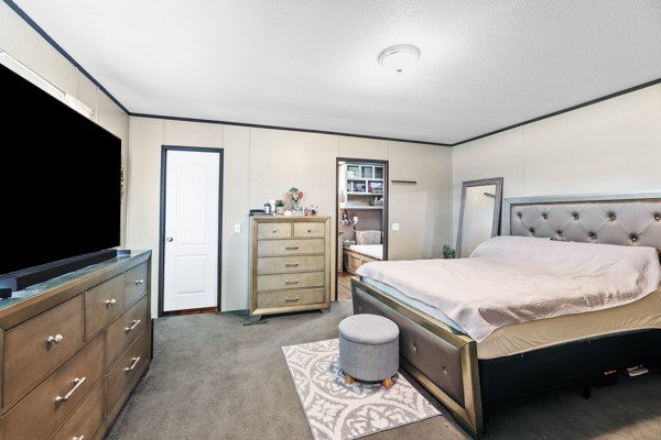 148 A Rogers Road New Waverly, TX 77358 - Photo 5 of 31 a bedroom with a bed and a flat screen tv