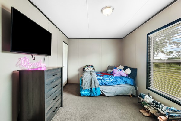 148 A Rogers Road New Waverly, TX 77358 - Photo 8 of 31 a bedroom with furniture and a flat screen tv