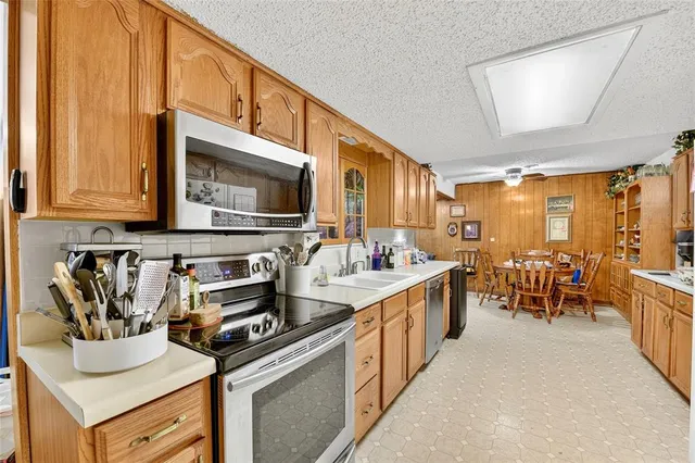 a kitchen filled with appliances a sink and cabinets