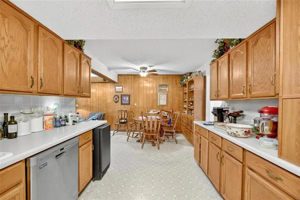 a kitchen with stainless steel appliances a refrigerator sink and cabinets