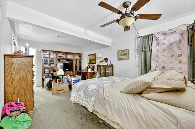 a bedroom with furniture and a flat screen tv
