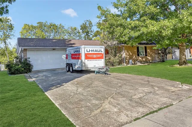 a sign board with parking space in back