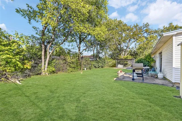 a view of green field with trees