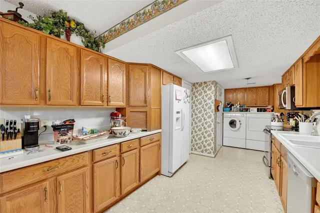 a kitchen with refrigerator and cabinets