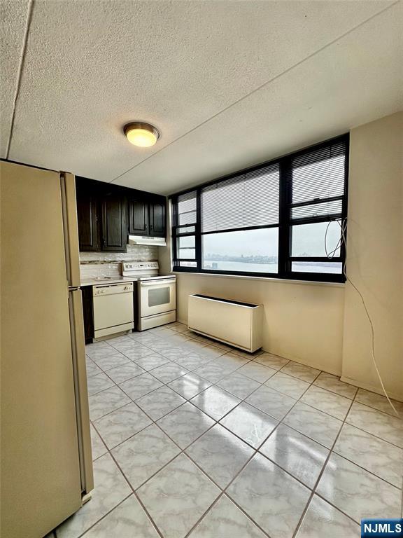 250 Gorge Road, Unit 23A Cliffside Park, NJ 07010 - Photo 13 of 41 a kitchen with stainless steel appliances granite countertop a refrigerator and a stove top oven