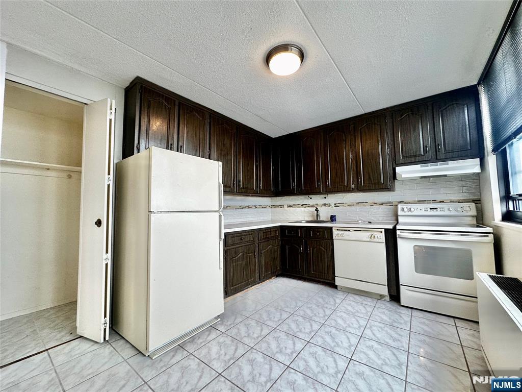 250 Gorge Road, Unit 23A Cliffside Park, NJ 07010 - Photo 14 of 41 a kitchen with granite countertop a refrigerator stove and sink