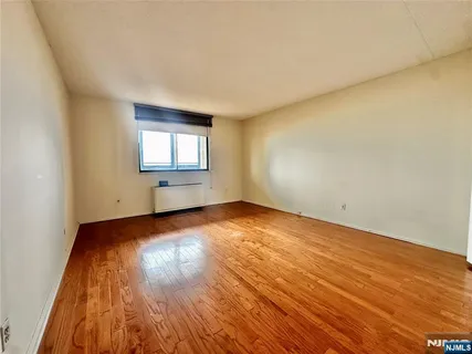a view of an empty room and wooden floor