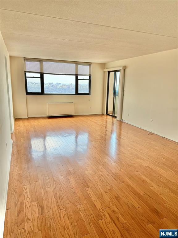 250 Gorge Road, Unit 23A Cliffside Park, NJ 07010 - Photo 4 of 41 a view of empty room with wooden floor and fan
