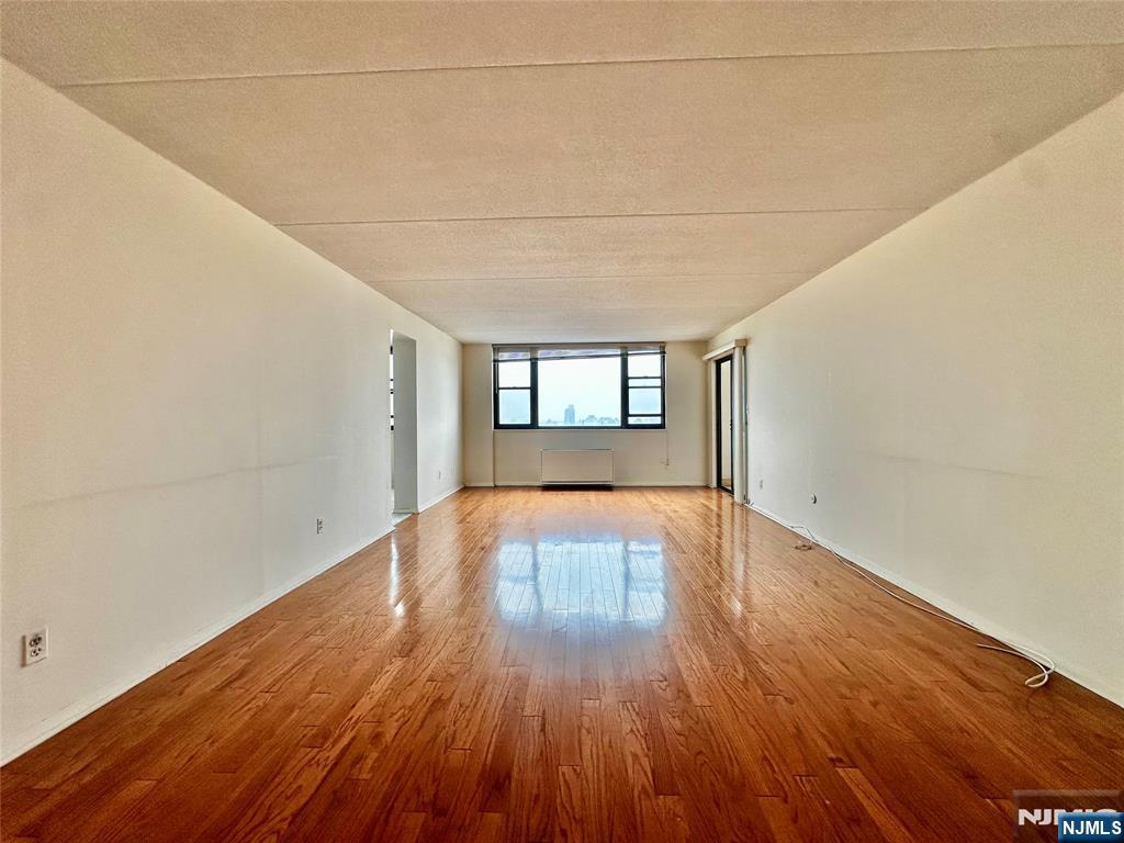 250 Gorge Road, Unit 23A Cliffside Park, NJ 07010 - Photo 9 of 41 a view of empty room with wooden floor and fan
