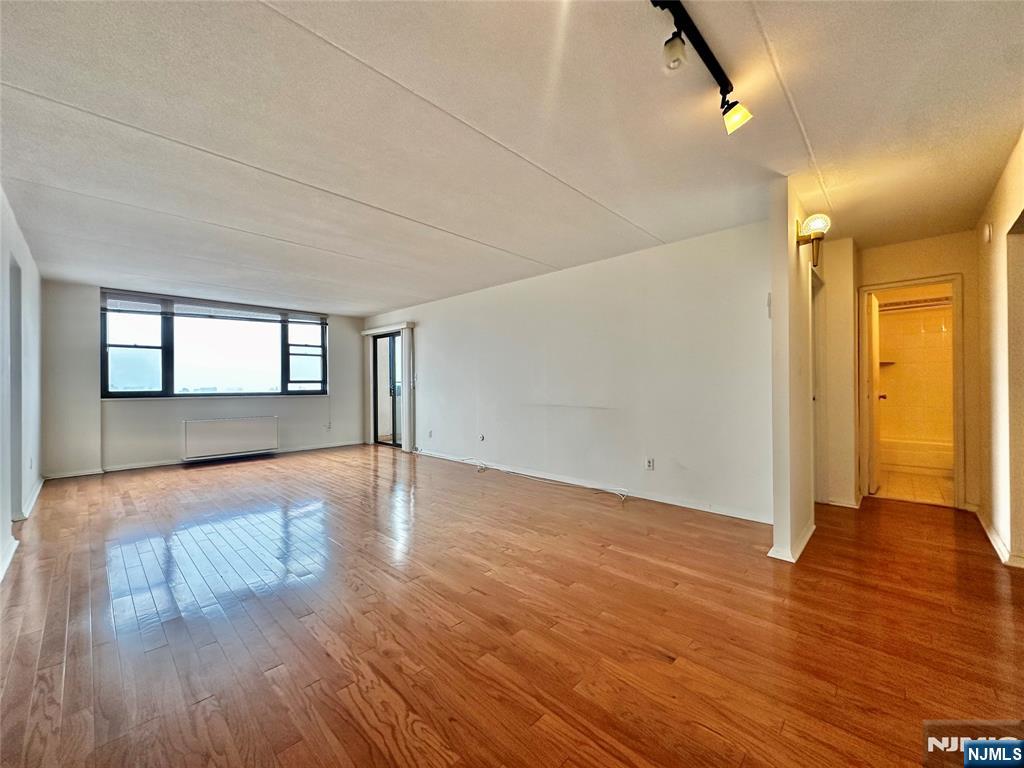 250 Gorge Road, Unit 23A Cliffside Park, NJ 07010 - Photo 10 of 41 a view of empty room with wooden floor and fan