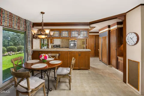 a dining room with furniture a table and a large window