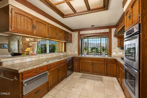 a kitchen with stainless steel appliances granite countertop a stove and a sink
