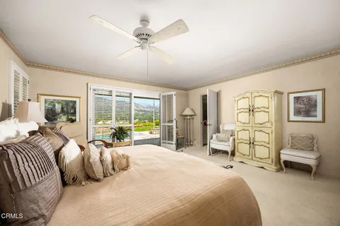 a bedroom with a bed and a painting on the wall