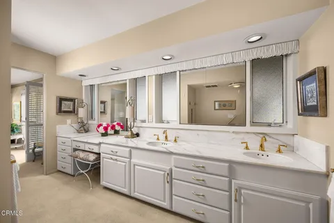 a bathroom with a granite countertop sink mirror and a toilet