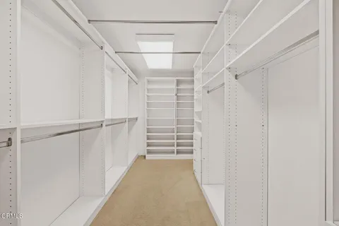 a bedroom with a bed chair and a large window