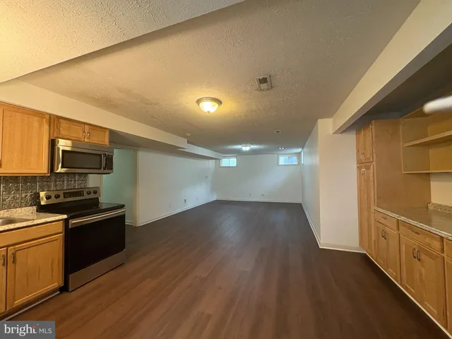 a view of a kitchen with a sink and a refrigerator