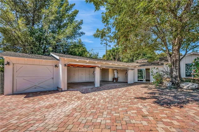 a view of a house with a swimming pool and a yard