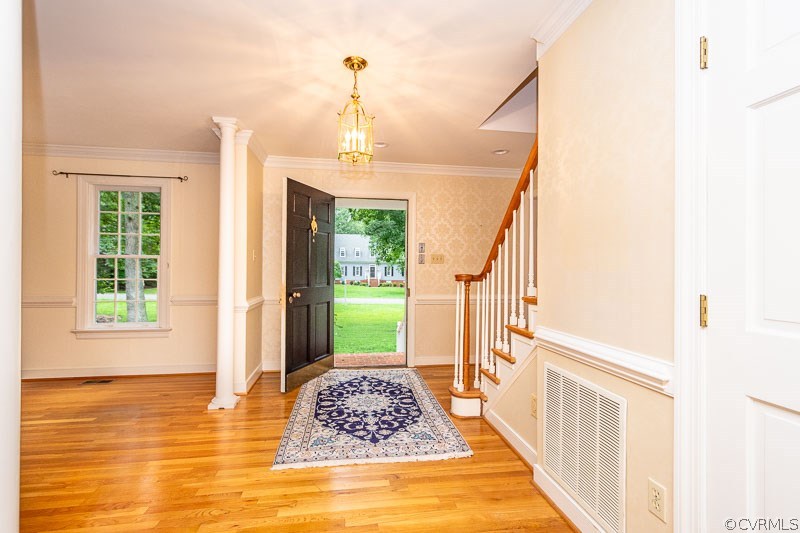 Open foyer with crown molding and chair rail