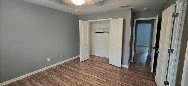 a view of a room with wooden floor