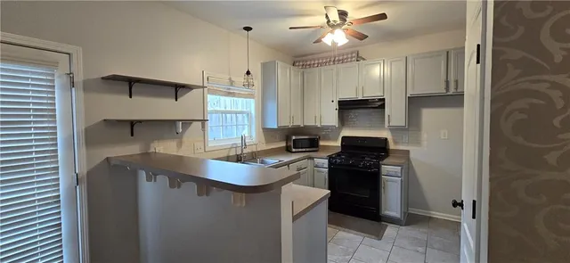a kitchen with stainless steel appliances a stove a refrigerator and a sink