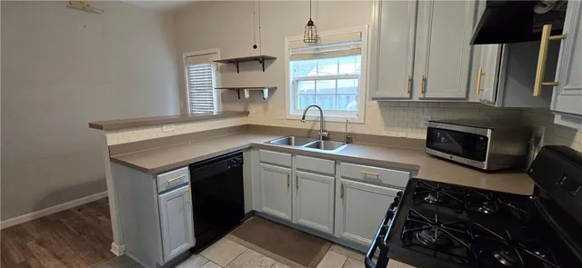 a kitchen with a sink stove and cabinets