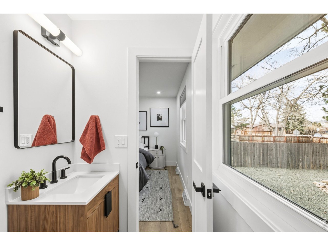 7750 Durham Way Boulder, CO 80301 - Photo 17 of 32 a bathroom with a sink vanity granite and a mirror