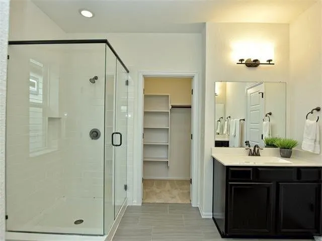 a bathroom with a double vanity sink shower and a mirror