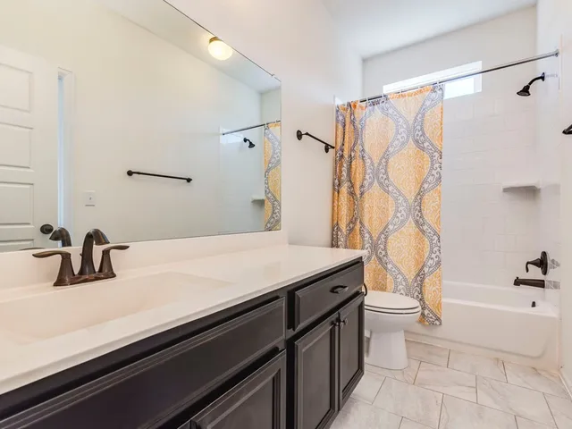 a bathroom with a sink a toilet and a bathtub