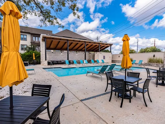 a view of a patio with a table chairs and a fire pit