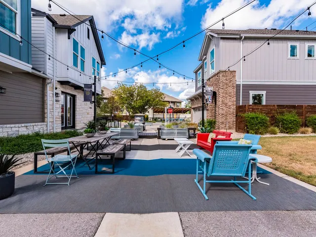 a backyard of a house with outdoor seating