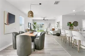 a living room with furniture a flat screen tv and a window