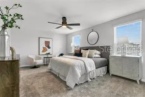 a bedroom with a bed and a chandelier