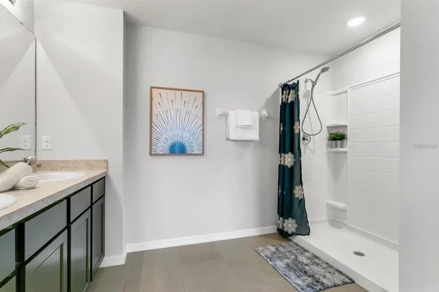 a bathroom with a shower and a sink