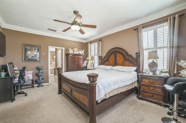 a bedroom with a bed and a large window