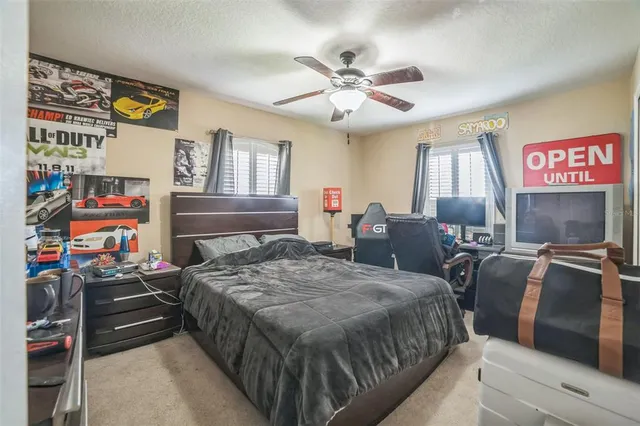 a bedroom with bed and a chandelier