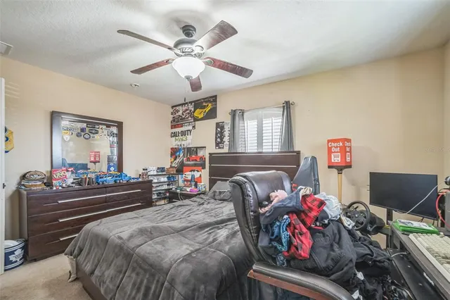 a bedroom with bed and a chandelier