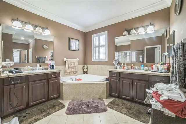 a spacious bathroom with a tub sink and mirror