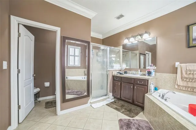 a bathroom with a tub a sink and a mirror
