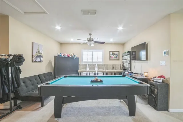 a room with furniture and pool table