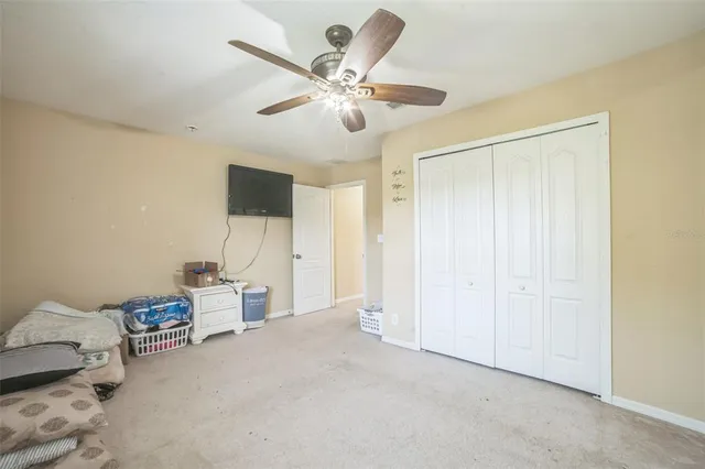 a view of a livingroom with furniture and a ceiling fan
